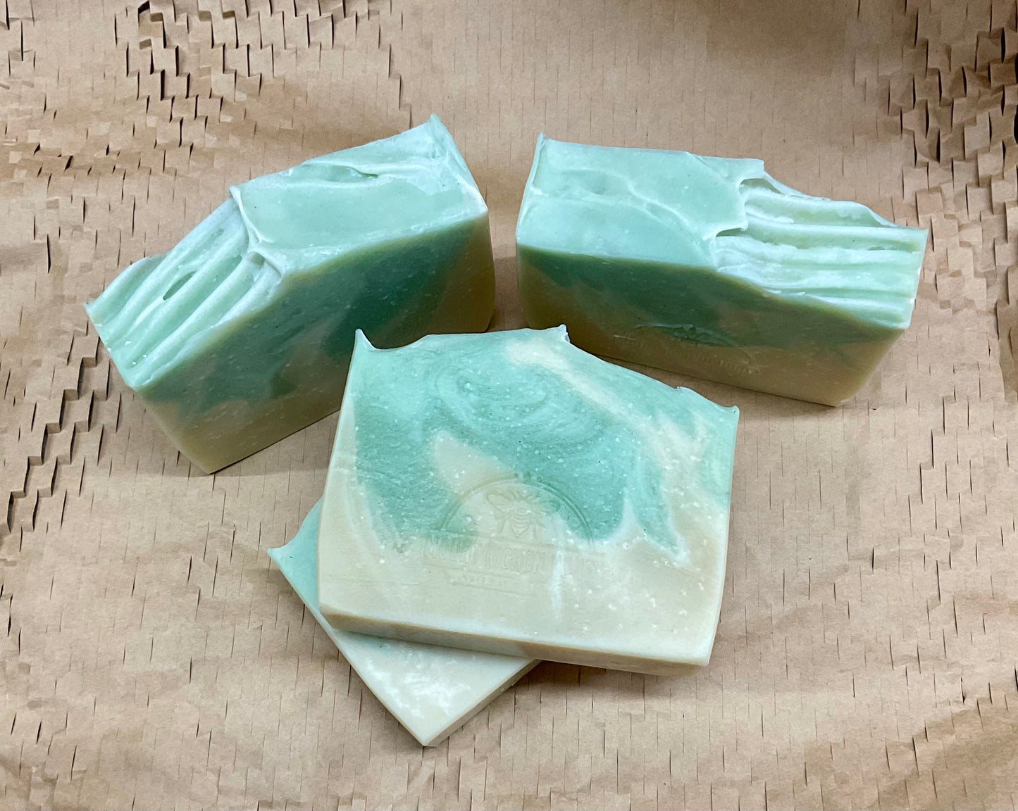 A sunlit bloom rising from red earth—Outback Bloom soap cradled in clay and light.