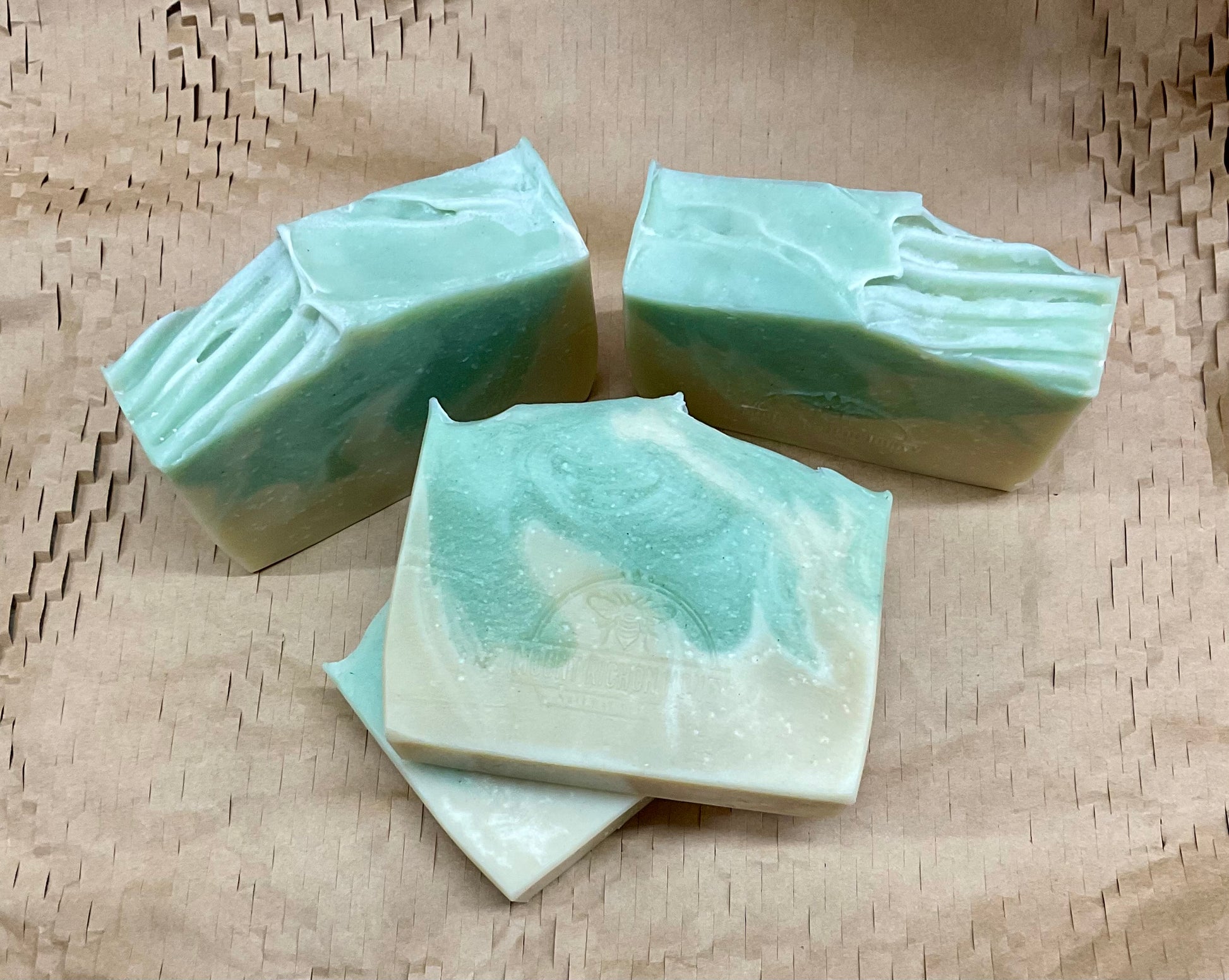 A sunlit bloom rising from red earth—Outback Bloom soap cradled in clay and light.