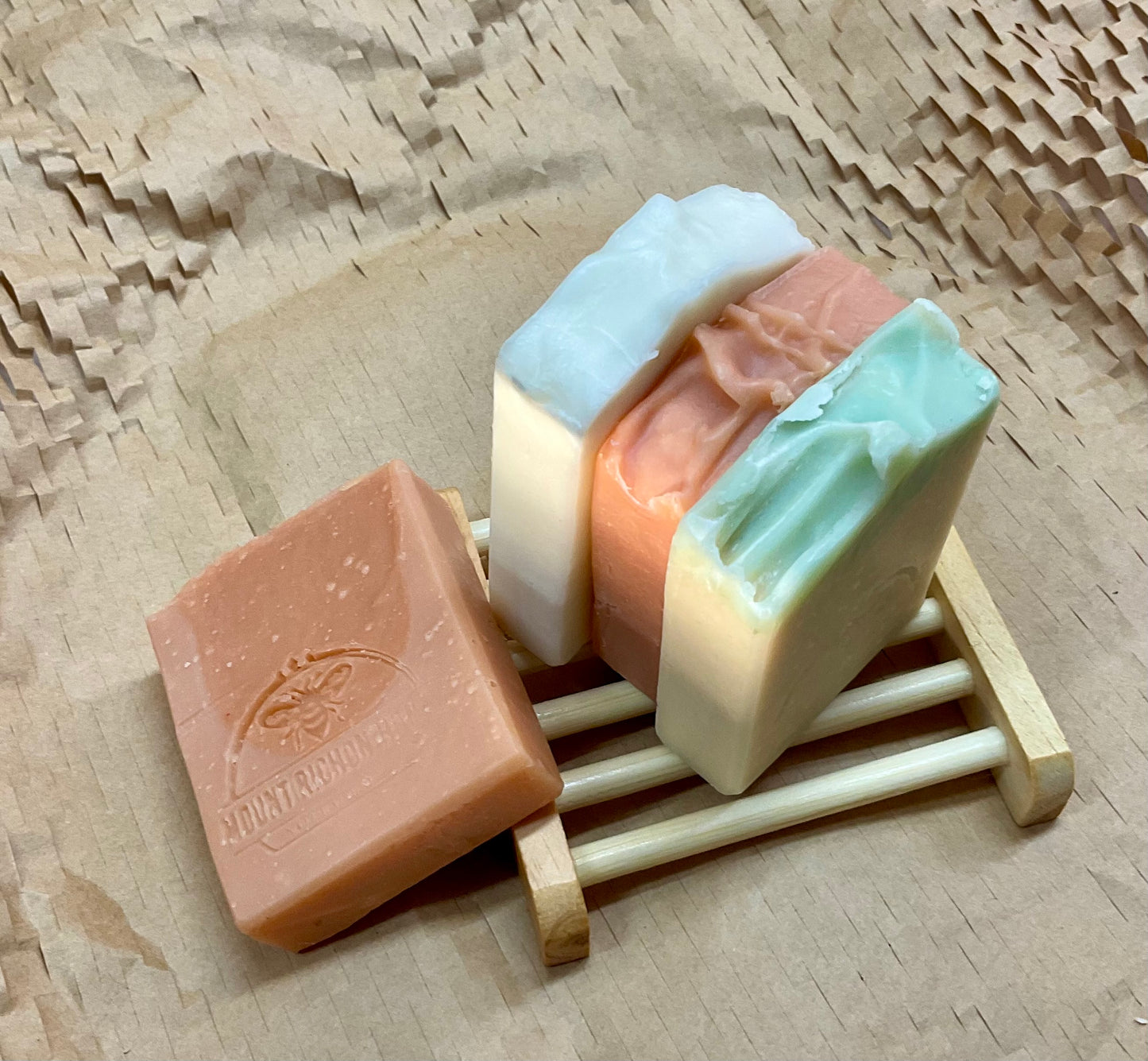 Tallow Soap Sampler with four artisan bars on rustic wooden holder