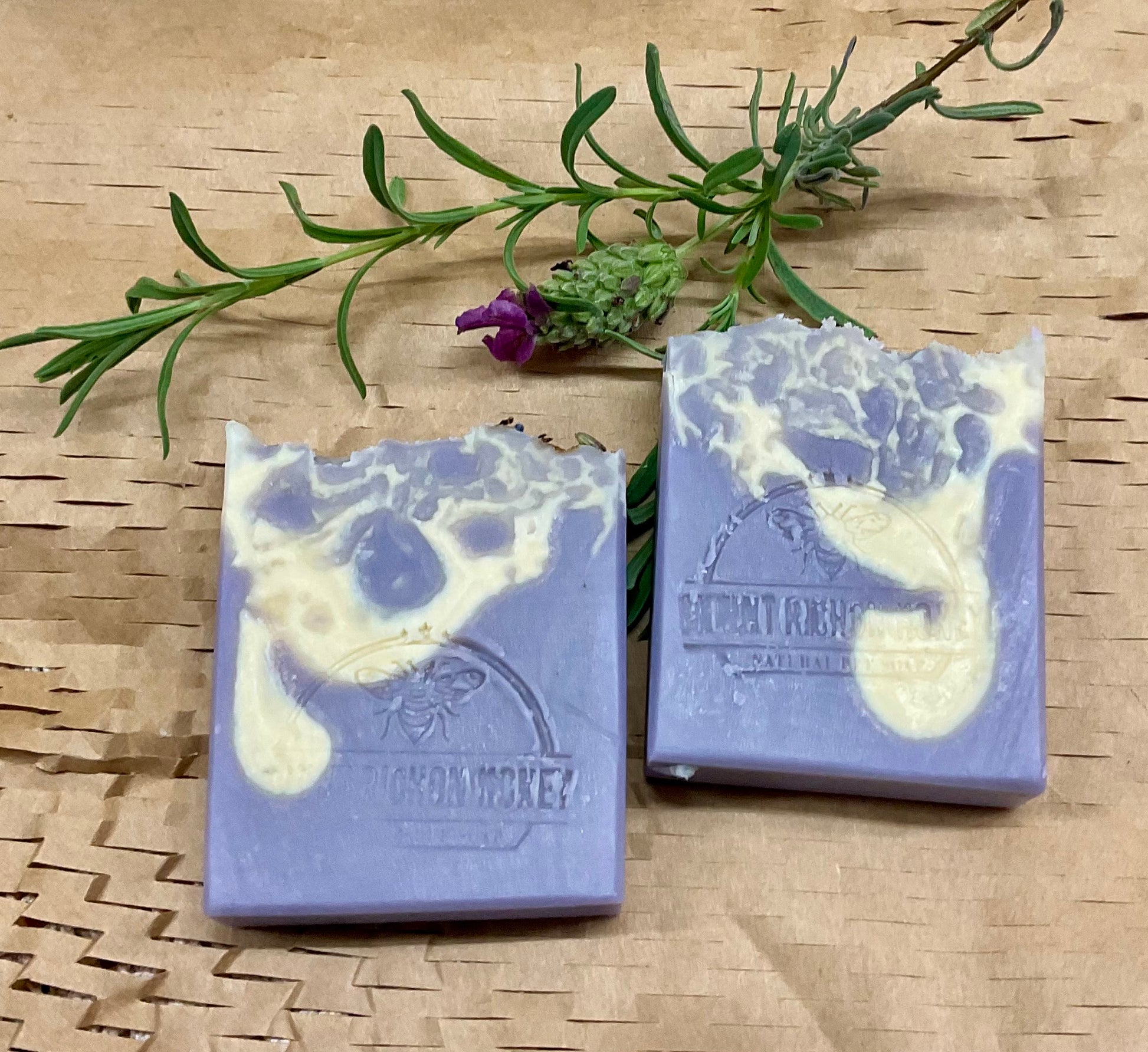 Artisan lavender soap infused with raw honey, nestled among dried blooms