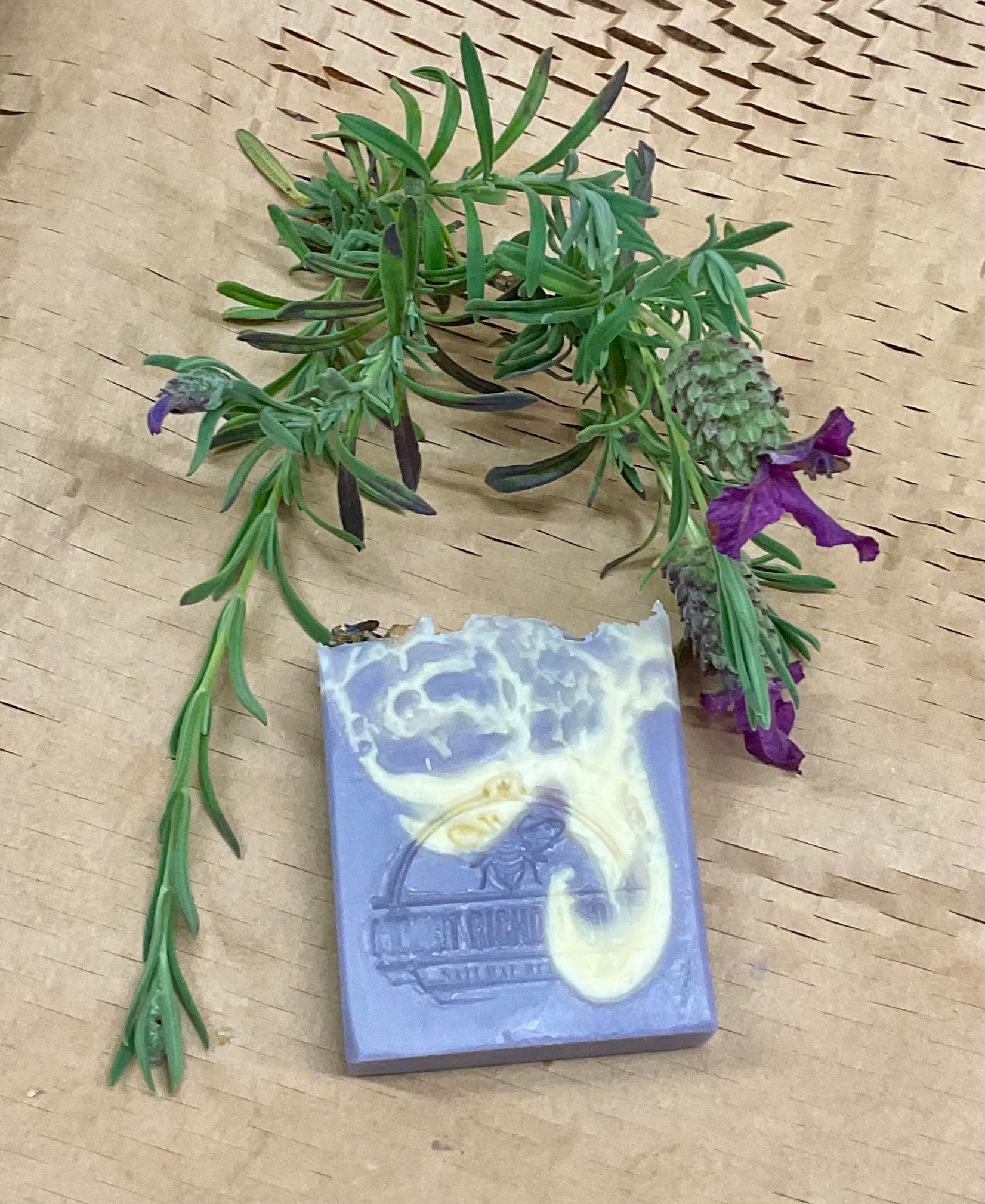 Cold process lavender soap bars with honey, styled on wood with floral accents